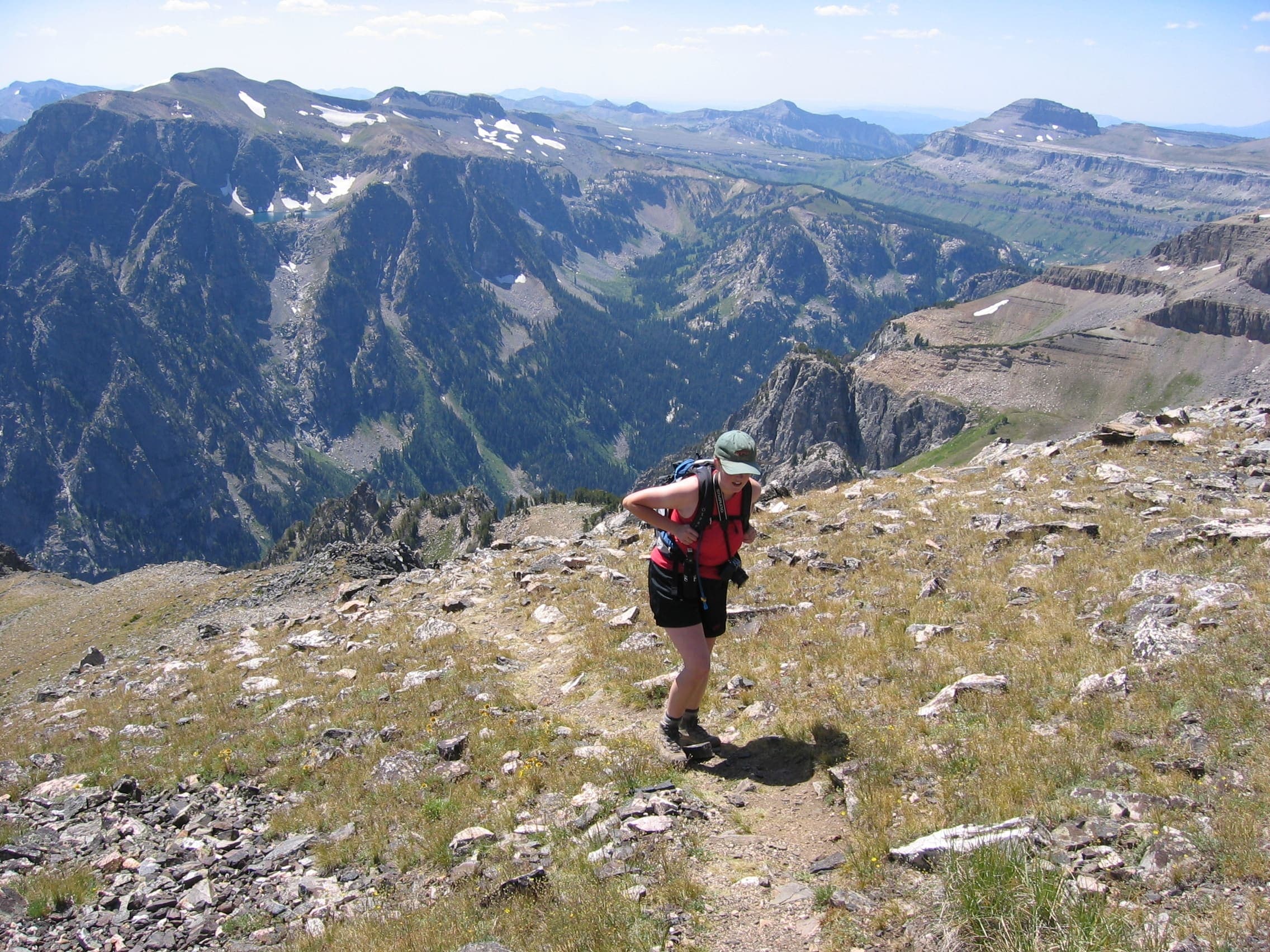 A hiker on Static Peak with the southern Tetons behind